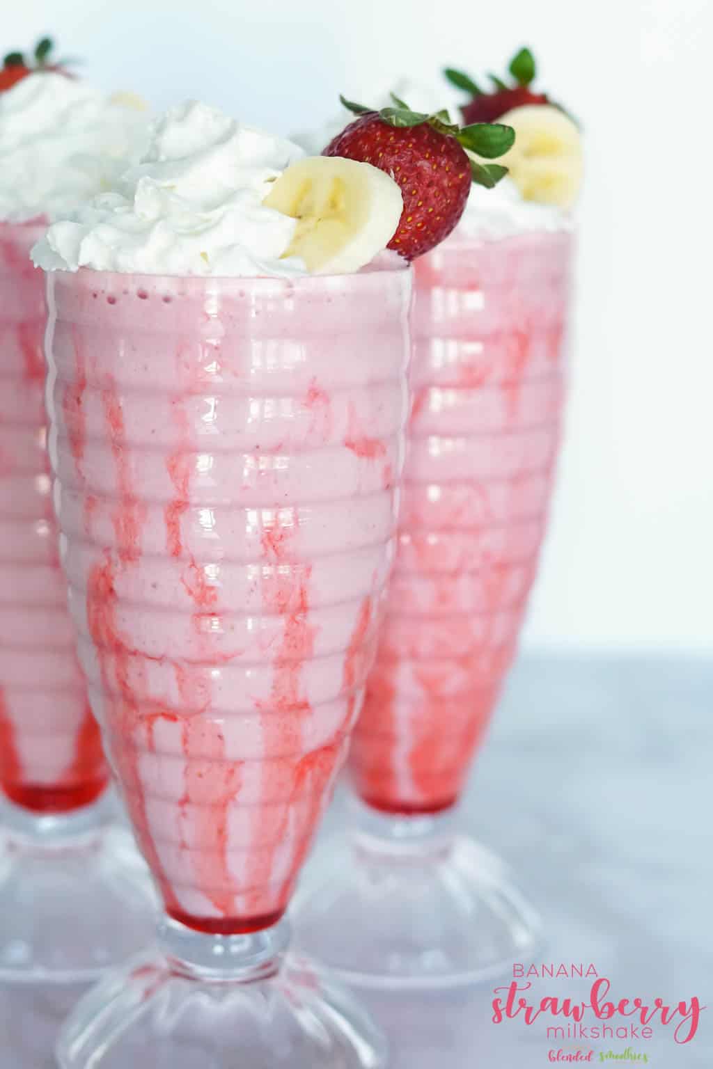 Banana, strawberry and chocolate milkshake in plastic cup with