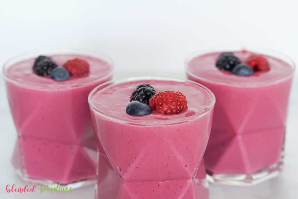 Horizontal Photo Showing Three Berry Smoothies With Berries On Top