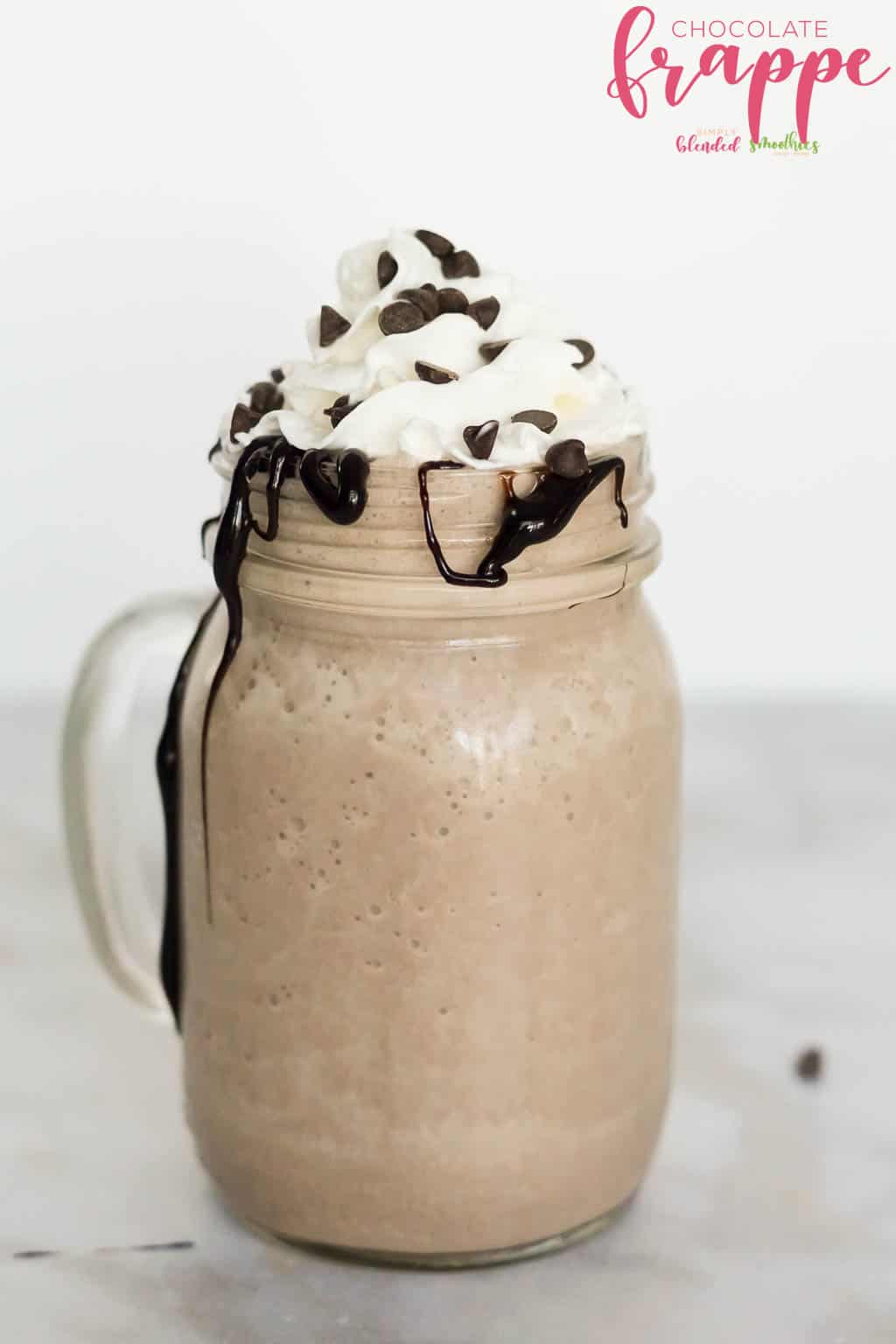 Chocolate Frappe Recipe In A Glass Cup With Whipped Cream Chocolate Drizzle And Mini Chocolate Chips