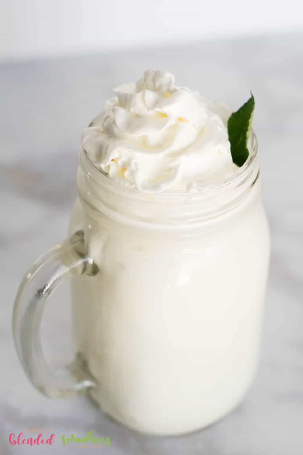 Vanilla Frappe With Whipped Cream And Mint Leaf