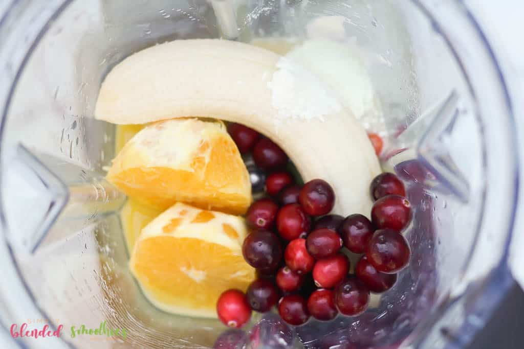 Ingredients In A Blender For This Orange Cranberry Smoothie