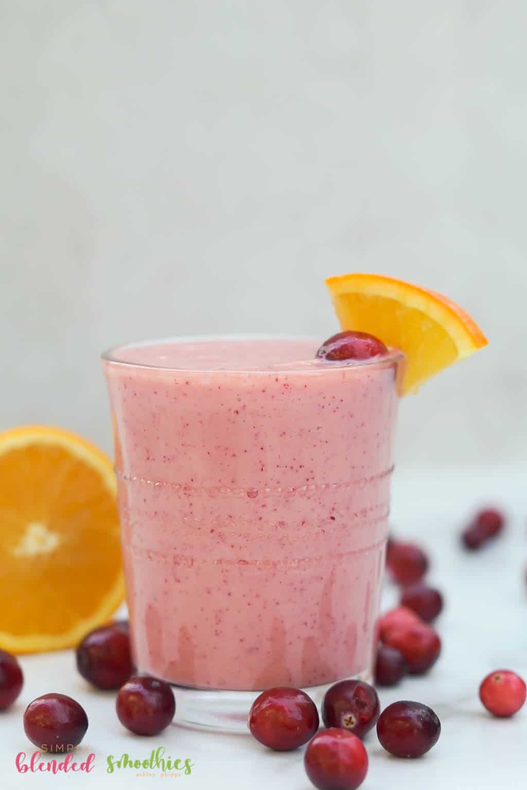 Cranberry Orange Smoothie In A Small Clear Glass