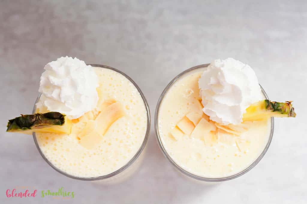 Photo Of A Pineapple Milkshake With Toasted Coconut Chips And Fresh Pineapple Slice