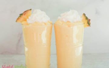 two mango pineapple milkshakes vertical photo