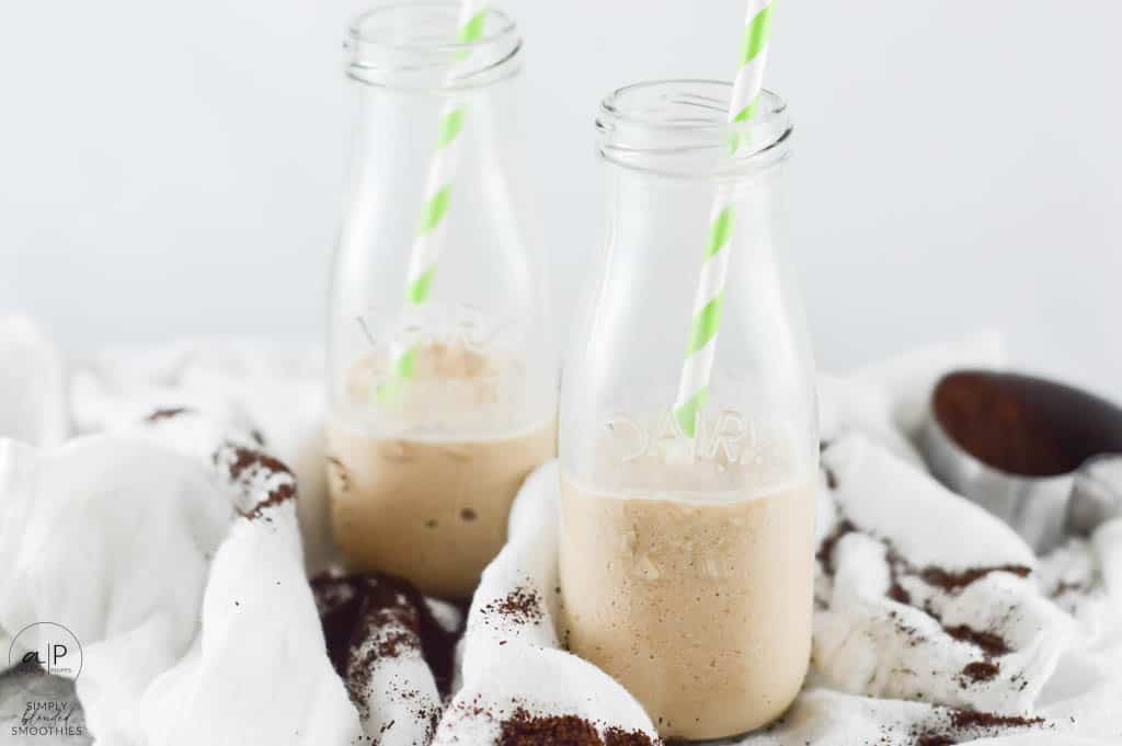 Half Full Coffee Smoothie In Milk Glasses With Green And White Straw