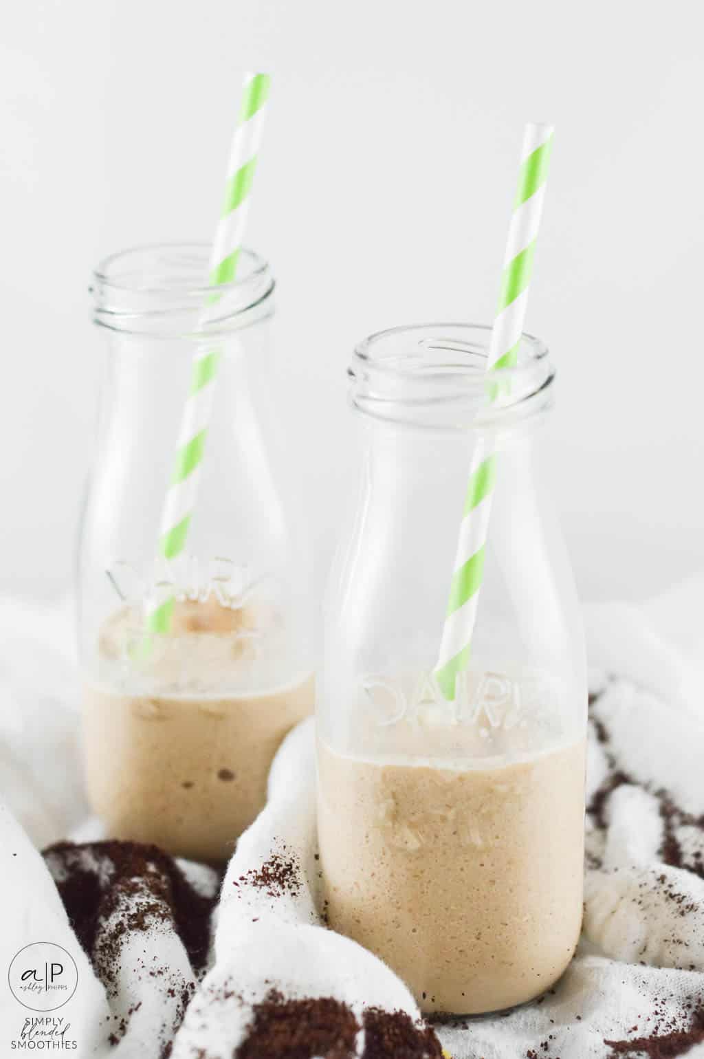 Two Glasses With Coffee Smoothie In Them Half Full With Straw
